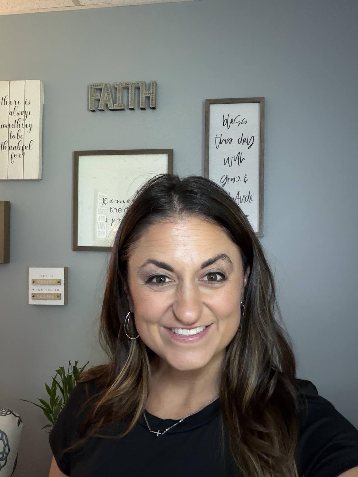 Laurice smiling and standing in her home office